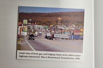 This is the display where my photo appears, discussing the Interstate Highway System.  It contains my photo of Breezewood from 2006 at center right.  My name is superimposed over the right side of the photo, and it's captioned, "Small cities of food, gas, and lodging chains arose where major highways intersected.  This is Breezewood, Pennsylvania, 2006."