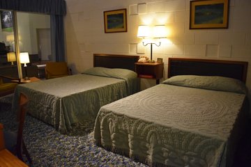 Reproduction of a Holiday Inn guest room.  Aside from the vintage furnishings, I was surprised at how austere the room looked.  The layout was mostly like a typical hotel room today, but I was surprised to see that concrete wall.  After all, no hotel today would ever make a room where the cinderblocks were visible to guests.