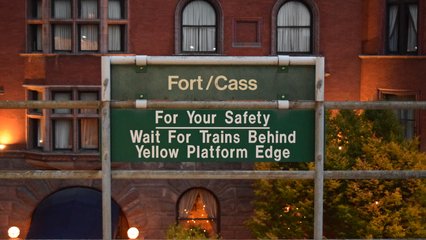 Trackside signage at Fort/Cass station.  The lower sign is provided in multiple languages along the length of the station.