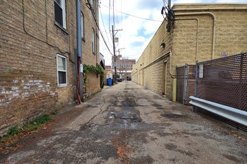 Going down another alley off of Oakley Avenue, behind the shopping center.