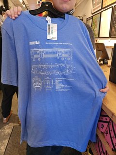 The CTA shirt, showing drawings of the 3200-Series railcars that were manufactured by Morrison-Knudsen.  Metro needs to offer something like this for their various car series.