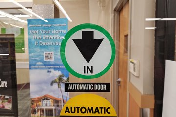 This was an unusual find for me.  This is the arrow sign at the entrance to Jewel-Osco, pointing downward instead of the usual up.  Note that the "IN" lettering is normal, i.e. this is placed correctly.  I've seen arrows like this going sideways before at a Consumers grocery store in Rogers, Arkansas, but never down.  It looks strange pointing that way.