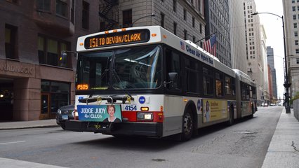 CTA bus 4154, a New Flyer D60LF, running the 151 at the intersection of West Jackson Boulevard and South Dearborn Street.