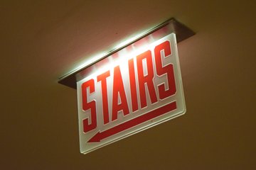 "STAIRS" and "EXIT" signage in the Hancock Center lobby.