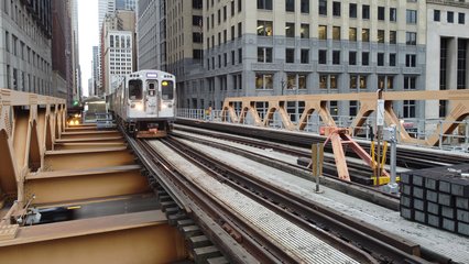 Trains cross the Chicago River, viewed from closer by (though the drone was still a very safe distance away).