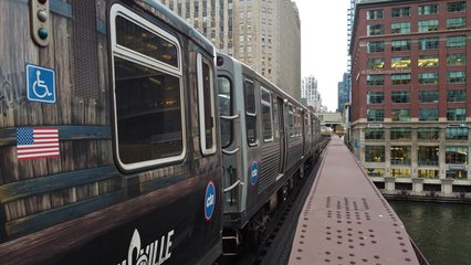 Trains cross the Chicago River, viewed from closer by (though the drone was still a very safe distance away).