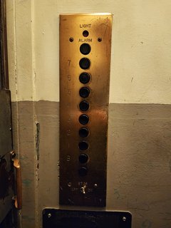 Button panel and inspection certificate on one of the elevators.