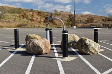 Part of the methane gas management system in the back of the Giant Eagle parking lot, protected by four bollards and four boulders.  Such a system is part of what comes with its being built on top of a former landfill.