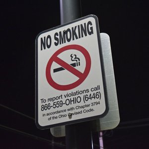 "No smoking" sign that also encourages citizens to report violations.  I have mixed feelings on this sign.  No smoking?  Cool.  But don't encourage people to snitch on others.