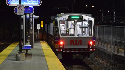 A Green Line train services East 55th Street station.