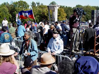 Behind the speaker's area, all sorts of people, with some wearing union-related apparel, others wearing more activist-style clothing (note the yellow "Free Mumia" shirt in the right-side photo), and some carrying flags, used the area as a sort of passageway from one side to the other. Park Police also kept an eye on the group on the steps from that location.