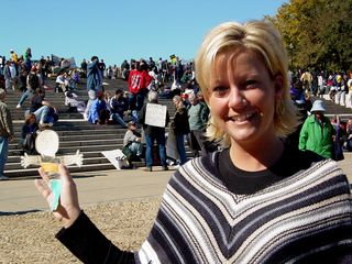 Woman holding "Flat Stanley" cutout