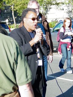 Larry Holmes stands in front at the microphone, leading the group.