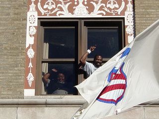 Three Hotel Washington employees lean out of a third-story window, lending support to our efforts to support them. Based on the expressions on their faces, you could tell that these workers were glad to see us coming.