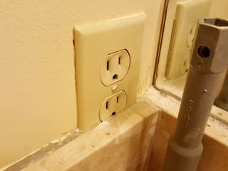 A trim panel for a sink had been placed over part of a power outlet.