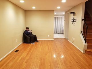 Elyse with her beanbag chair in the otherwise empty living room on the night after closing.  That beanbag chair was, at that time, the only piece of furniture in the whole house.