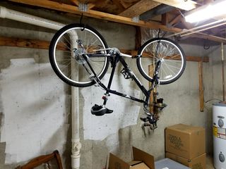 My bike, hanging on hooks in the utility room.