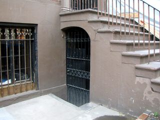 I specifically looked to see if there was a basement entrance that might represent the entrance to Cliff's office, and I found one. This is under the front stairs.