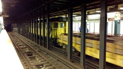 I spotted a work train going through on the uptown express track. I want to say that the yellow subway car that's part of this train is a former Redbird.