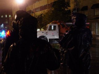 Seeing a city dump truck parked along a street during a protest march almost certainly reminded those who were in the black bloc march on September 24 about an incident where two similar trucks were tagged.