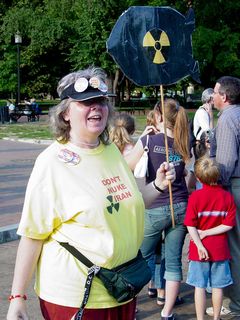 Carol Moore holds up her sign, designed to look like a nuclear bomb.