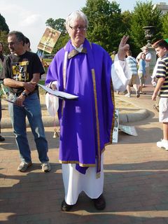 David Barrows gives a peace sign for the camera, looking quite sharp in his clergy robes, ready to conduct an exorcism.