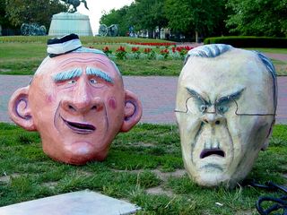 The oversized Bush, Rumsfeld, Cheney, and Rice heads sit on the ground, awaiting the time when they will be put to use.