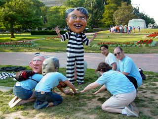 With the person wearing the Condoleezza Rice head all set and ready to go, a group formed around her and bowed down to her.