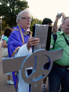 David Barrows conducts the exorcism on the White House, while many look on and join in.