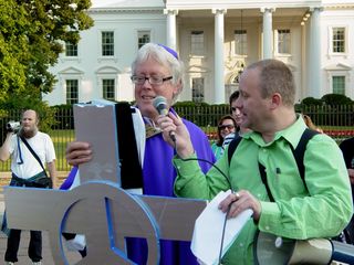 David Barrows conducts the exorcism on the White House, while many look on and join in.