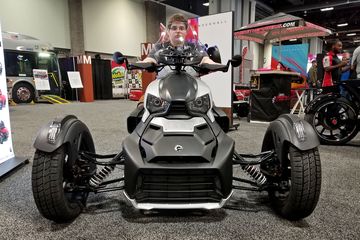 Elyse poses for a photo on a Bombardier three-wheel motorcycle.