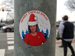 Around the time of this trip, one of the bigger political events to have occurred was the recent impeachment of then-president Donald Trump.  This was related to that, showing a photo of House Speaker Nancy Pelosi wearing a Santa hat, with the words "Merry Impeachmas!" around it.