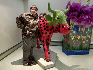 Elyse poses with "Strawberry Cow" at Strawberry Square in downtown Harrisburg.  This statue is from the "Cow Parade" event that occurred in Harrisburg in 2004.