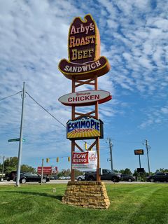 The full sign, with other signs for rotisserie chicken and frozen treats.