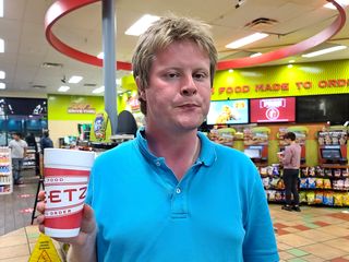 Brian holds up a styrofoam cup at the Sheetz in Rocky Mount.