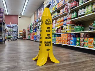 Banana wet floor cone in the soda aisle.