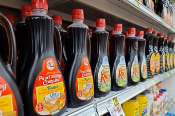 Bottles of Pearl Milling Company syrup on the shelf at Piggly Wiggly, with one bottle's still carrying the older Aunt Jemima name.