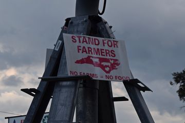 "Stand for farmers" sign on the irrigation rig.