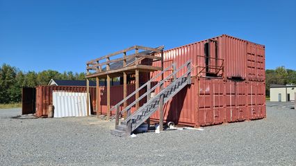 A structure on the property built out of shipping containers, presumably used for training purposes.