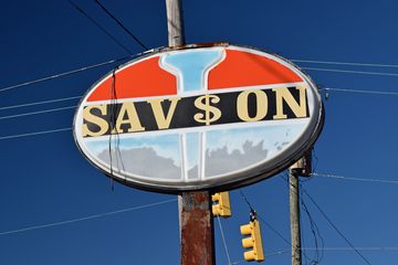 Sign for "SAV $ ON", created over what was formerly an Amoco torch-and-oval sign, at the intersection of Roanoke Avenue and First Street.