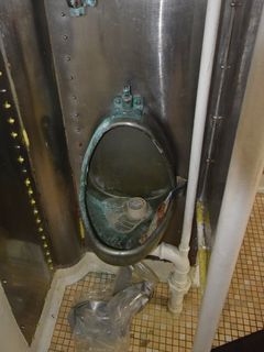 Metal urinal.