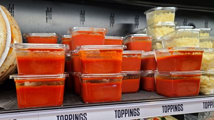 Containers of tomato sauce, intended for pizza.  I looked at these, and I couldn't help but think that it looked like containers of blood.