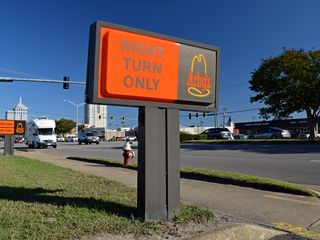 Despite the vintage street sign, though, the drive-through signs were from a later period, using the company's second logo, which was used until the 2010s.