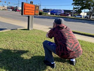 Evan got a photo of me Slav-squatting while photographing the Arby's sign.
