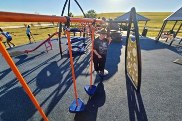 Elyse crosses a part of the play structure.
