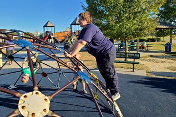 Elyse climbs on a metal dome.  These things always remind me of the "link set" on You Can't Do That On Television.