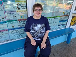 Elyse is all smiles on the bench in front of Shoofly just before we ordered.