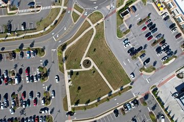 Grassy area in the middle of the shopping center.  I am sitting on the bench around that circular formation, flying the drone.