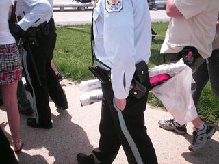 A Park Police officer carries the confiscated banner.