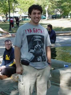 Sascha smiles for the camera in Franklin Square, wearing a "¡Ya basta!" t-shirt.